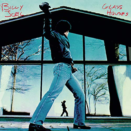 Billy Joel’s “Glass Houses” album cover featuring a man and reflection.