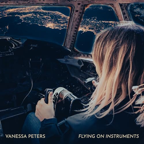 Woman in a cockpit looking at a city night view.