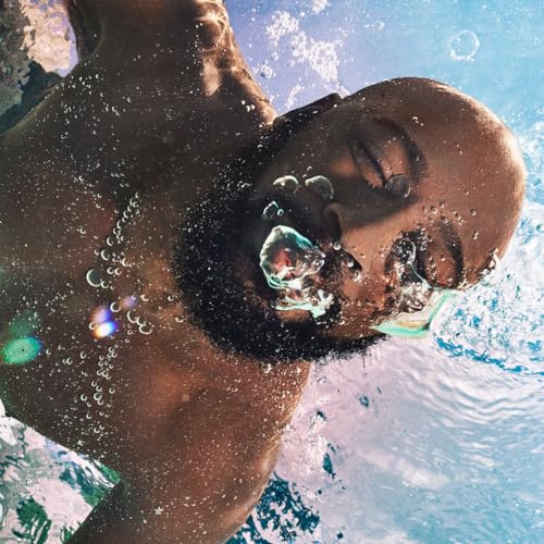 Close-up of a Black man’s face partially submerged in blue water.