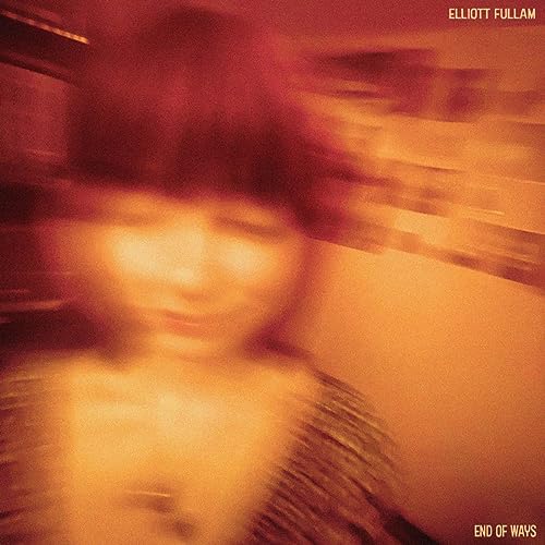 Blurred portrait of a person in warm orange tones, album cover.