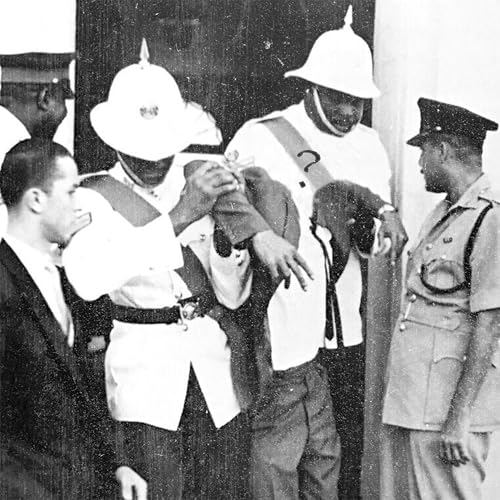 Black and white photo of colonial officials and restrained man.
