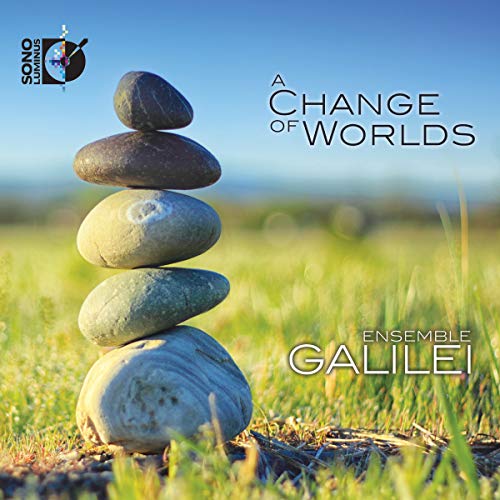 CD cover: stacked stones in grassy field, blue sky background.