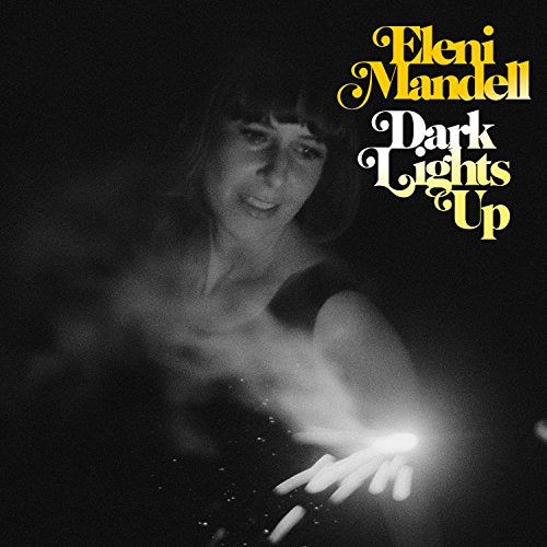 Black and white album cover featuring a woman holding a light.