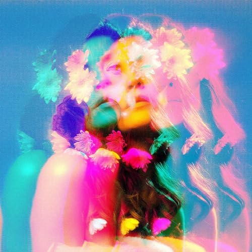 Blurred portrait of a person surrounded by colorful flowers and light.