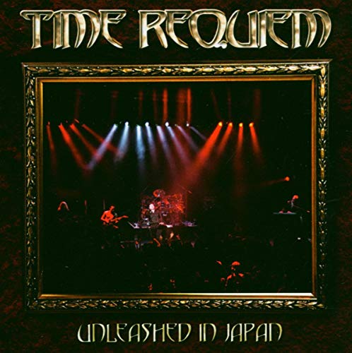 CD cover: concert stage with band performing, framed in gold.