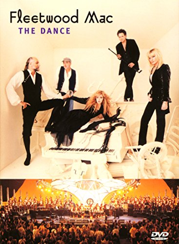 Fleetwood Mac band members posed with a piano and concert crowd below.