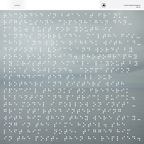 CD cover with a blurred landscape and dense braille pattern.