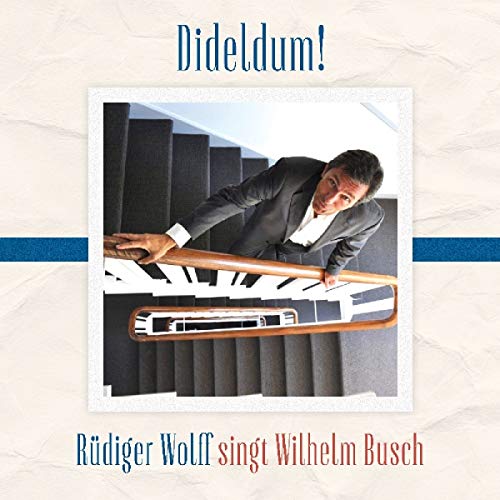 CD cover: man in a suit appears to fall down stairs.