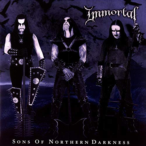 Three dark-clad figures with face paint stand against a dark background with bats.