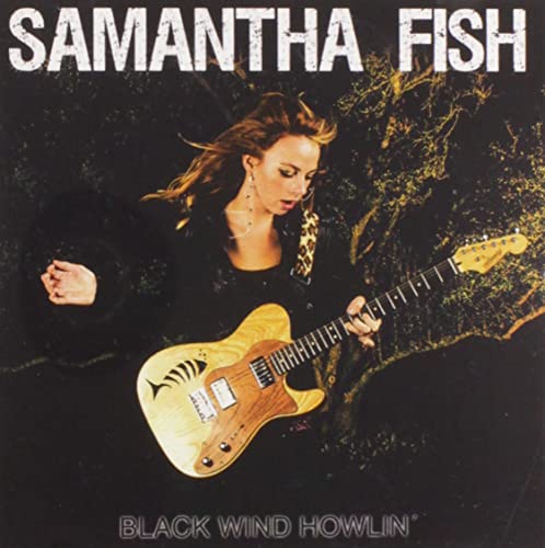 Samantha Fish album cover: woman with guitar against a dark, textured background.
