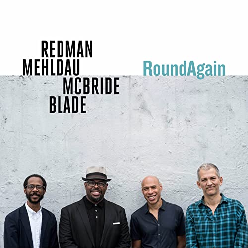 Album cover featuring four musicians against a textured grey wall.