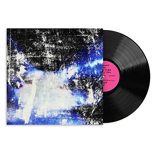 Vinyl record with abstract blue and white textured album cover.