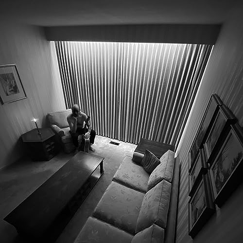 Black and white album cover depicting a person in a room with curtains.