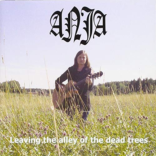 CD cover: woman with acoustic guitar in a field of wildflowers.