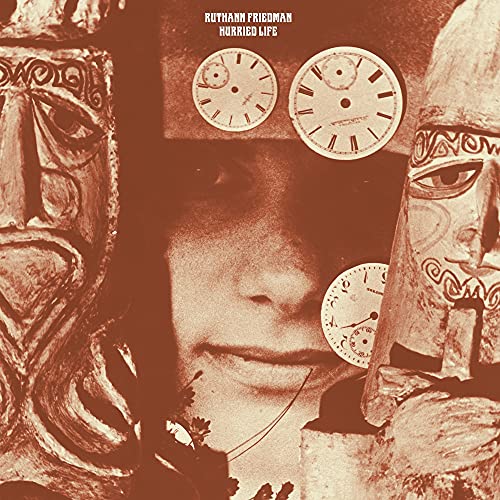 Sepia-toned album cover with a face framed by masks and clocks.