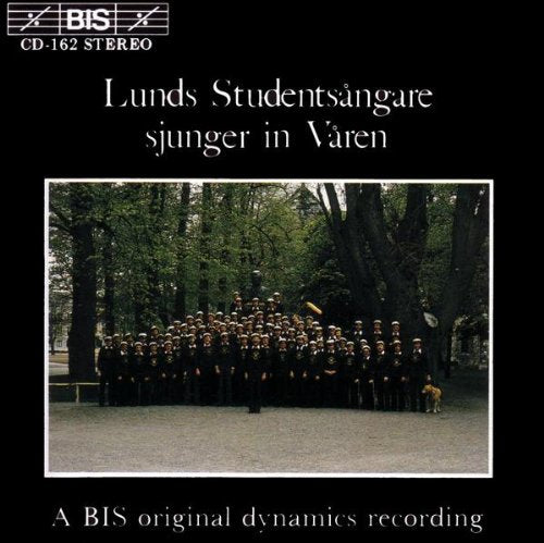 CD cover: choral group in dark suits standing beneath trees.