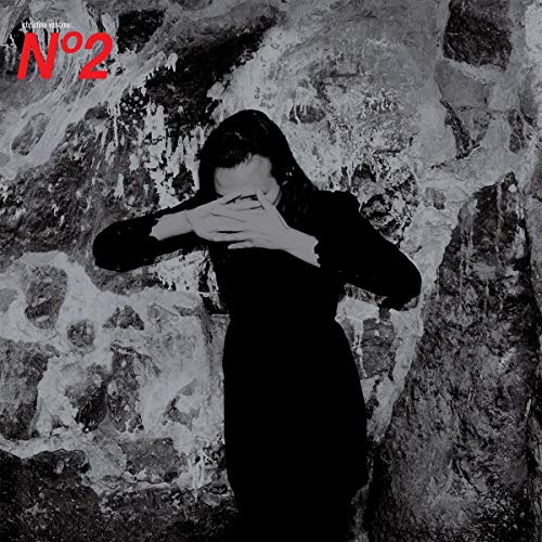 Black and white album cover featuring a person obscuring their face.