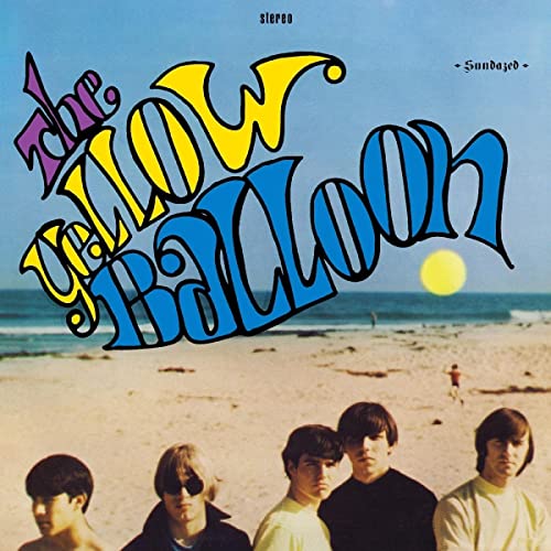 Album cover for "The Yellow Balloon" featuring a beach scene and band.