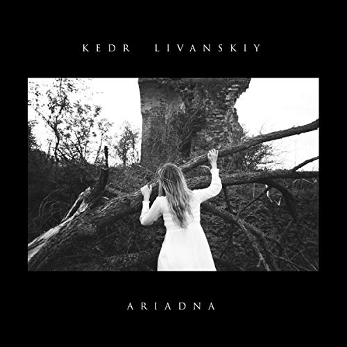 Black and white CD cover with a woman near a large, gnarled tree.