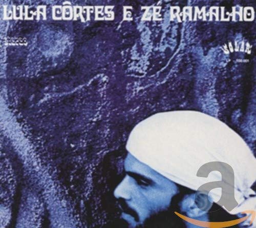 CD cover: man with white headwrap against a textured purple background.