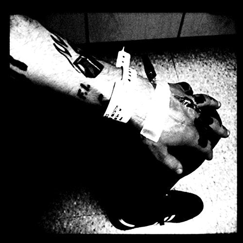 Black and white image of a hand holding a vinyl record.