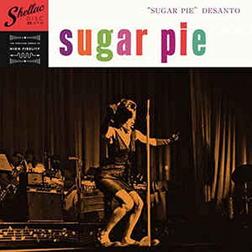 Vintage record cover featuring a singer with a band on stage.