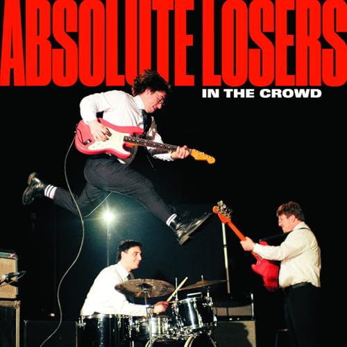 CD cover: band members performing, jumping, and playing instruments onstage.