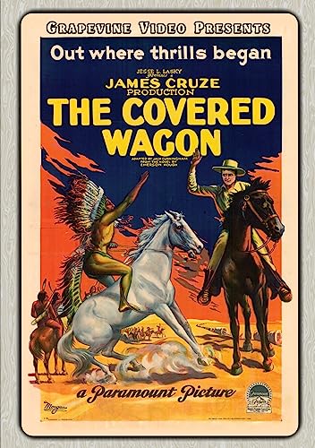 1923 movie poster for "The Covered Wagon" featuring cowboys and Native Americans on horseback.