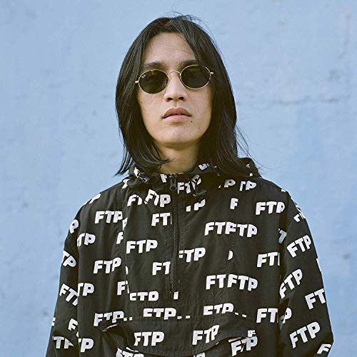 Eyedress portrait, wearing round sunglasses and a patterned black jacket.
