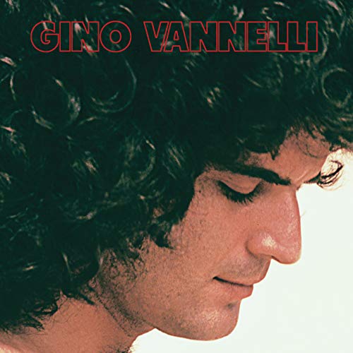 Close-up profile portrait of Gino Vannelli with curly hair and red text above.