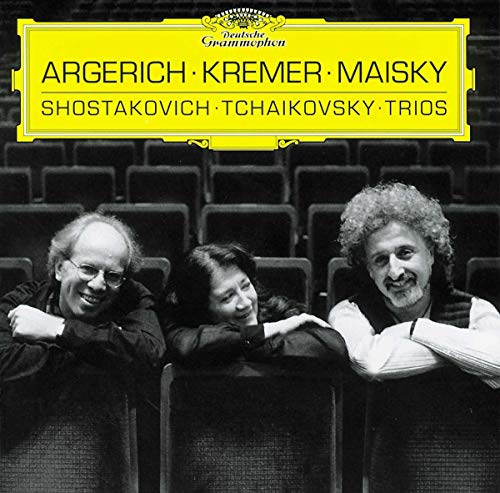 CD cover featuring three musicians seated in rows of empty theatre seats.