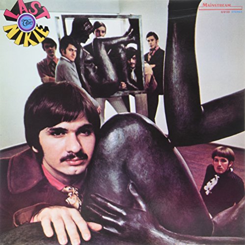 Album cover for "Last Nickle" featuring a band near sculptures.