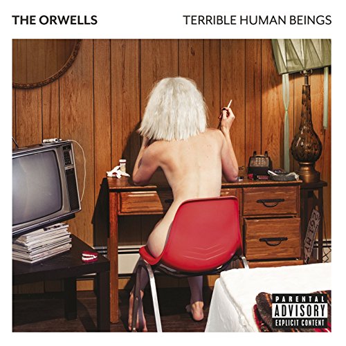 Album cover: person with white hair seated at a wooden desk.