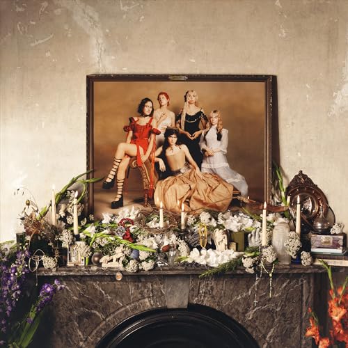 Five women in ornate dresses posed as a classical painting.