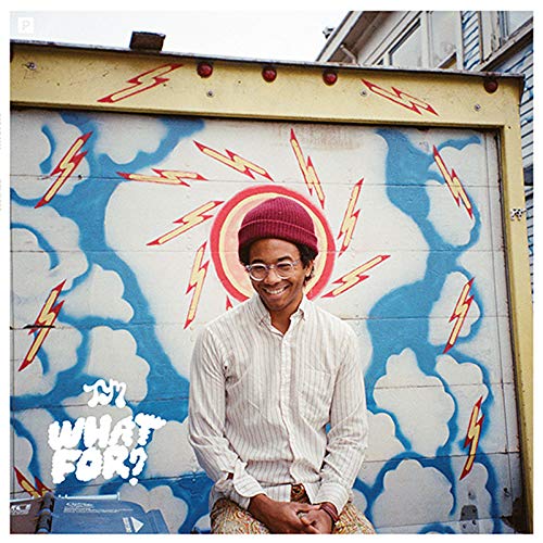 Man with red beanie smiles in front of painted lightning bolts.