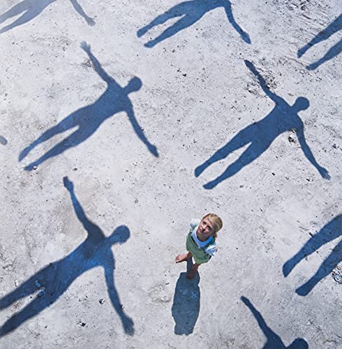 Album cover for Muse’s “Absolution” showing a boy and distorted shadows.