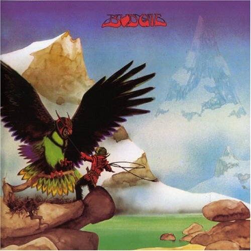 A figure in red interacts with a large bird against a snowy mountain landscape.