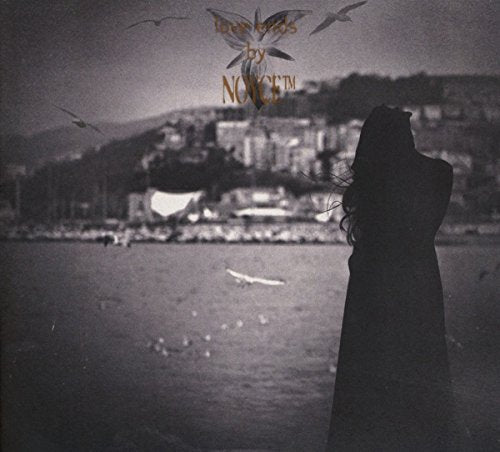 Black and white CD cover with a silhouetted figure overlooking water.