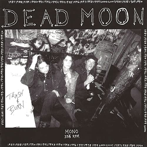 Black and white vinyl record cover featuring a band in a dimly lit room.
