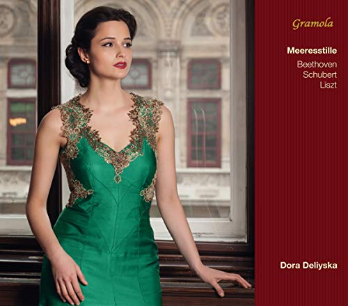 Woman in a green embroidered gown standing by a window on album cover.