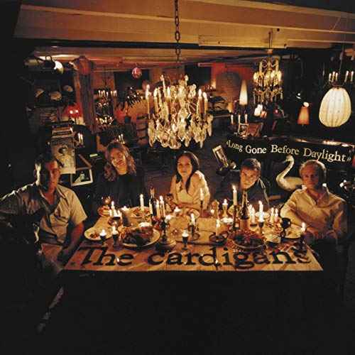 The Cardigans band seated around a candlelit table, album cover art.