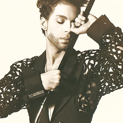 Sepia-toned portrait of Prince with eyes closed, holding a guitar.