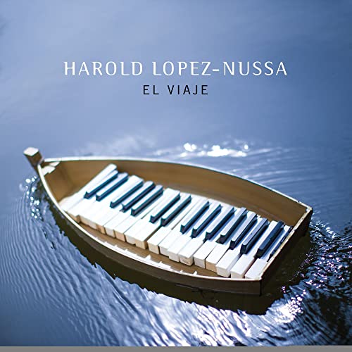 CD cover: a small wooden boat containing a piano keyboard on water.