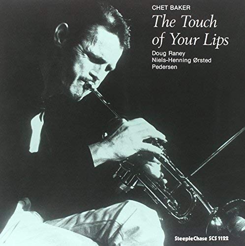 Chet Baker playing trumpet, album cover with black and white portrait.