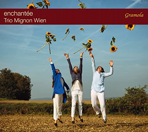 CD cover: three people jumping with sunflowers in a field.