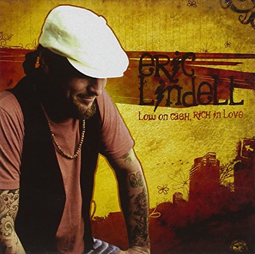 CD cover featuring Eric Lindell in a white cap, with tattoos visible.
