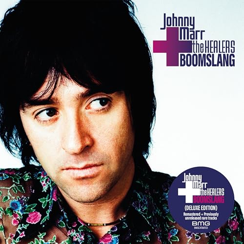 Portrait of Johnny Marr wearing a floral shirt with album text in the corner.