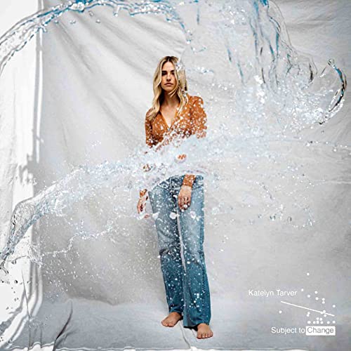 Katelyn Tarver stands amidst flowing water, album cover for “Subject To Change”.