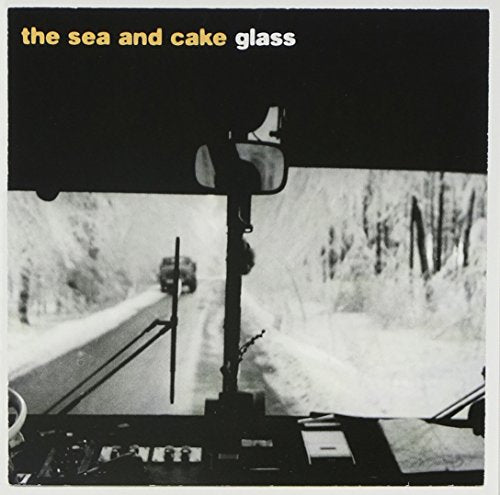 Black and white album cover with a road seen through a car window.