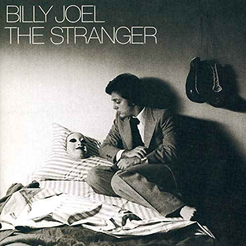 Billy Joel’s “The Stranger” album cover: man in suit, mask on pillow.